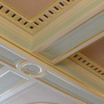 Close up of gold leaf and pastel colours on centre of painted ceiling