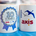Two mugs with Axis and Swan logos on